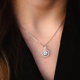 Елегантно сребърно колие с блестящ камък, носено от жена, подходящо за специални поводи.